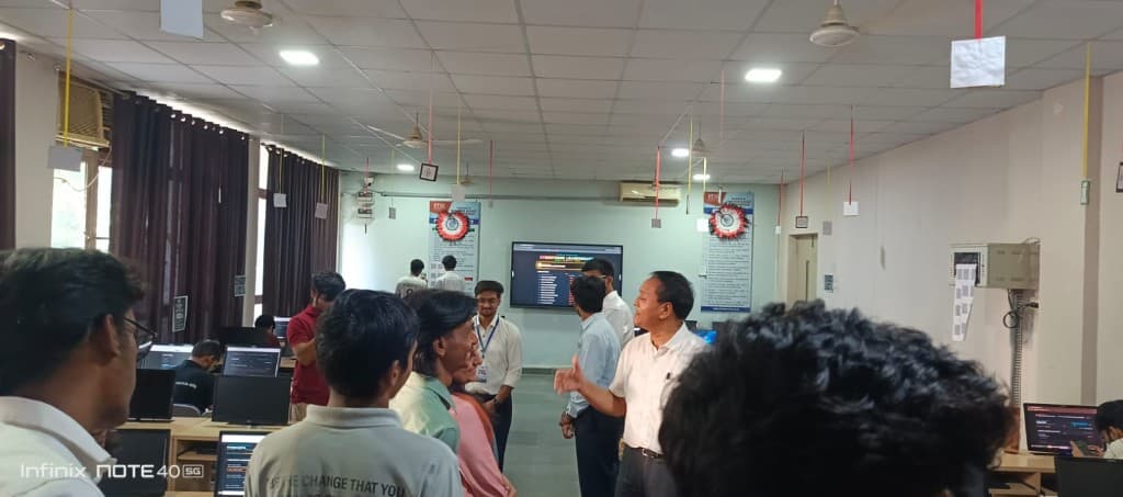 A faculty member briefing CyberForge participants in the computer lab.