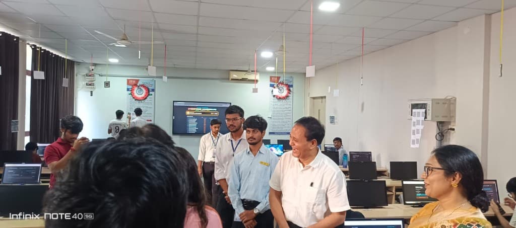 Faculty visiting the CyberForge lab while students work at their computers.