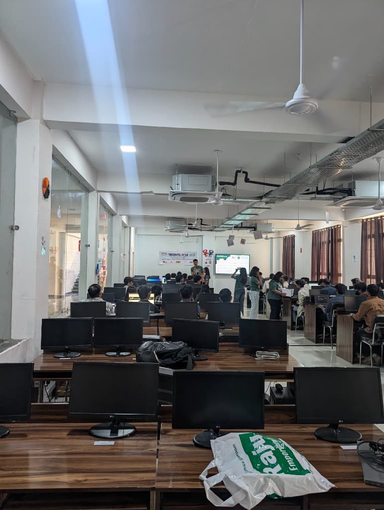 Looking across the lab rows toward the Hacktoberfest screen at the front of the room.